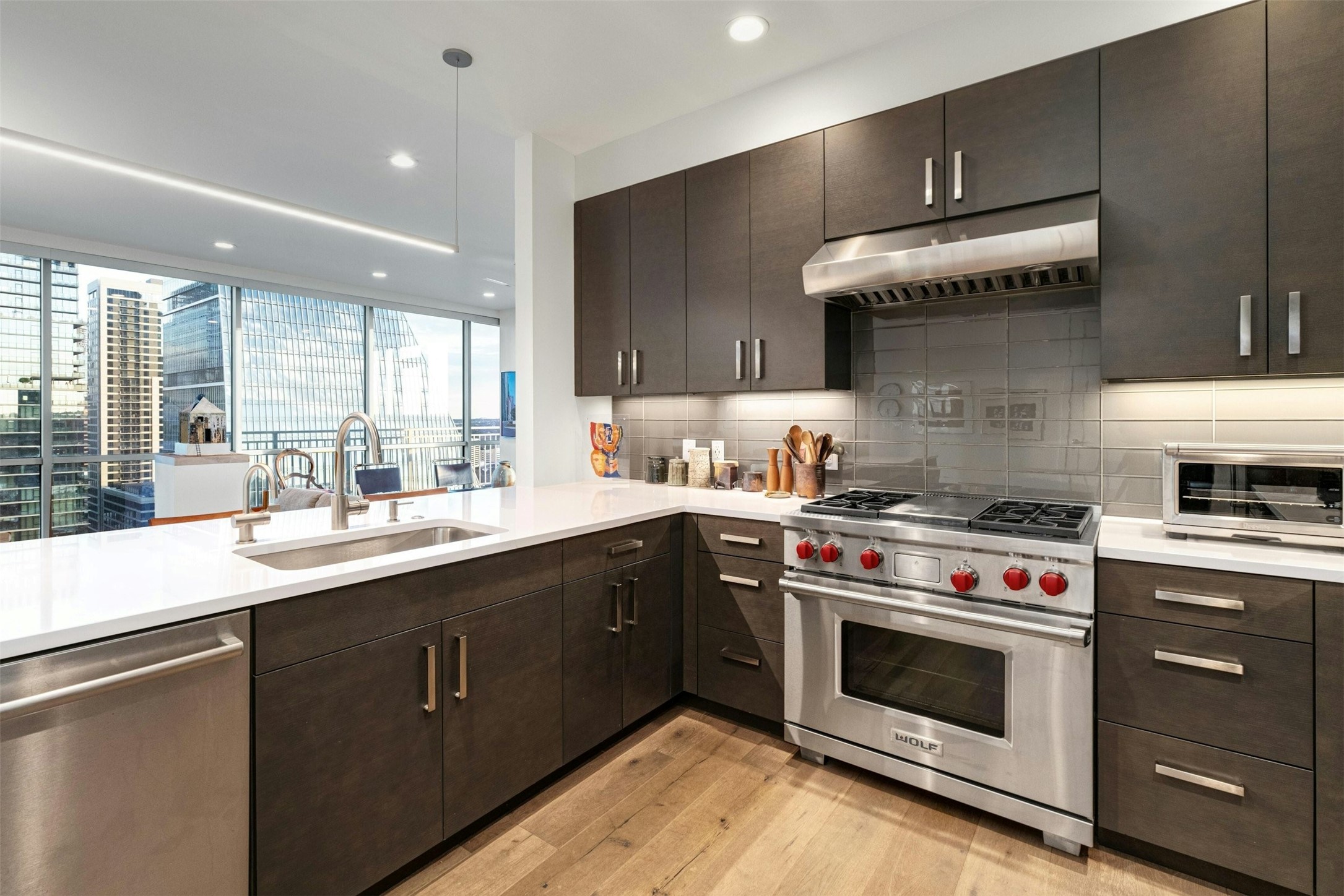 222 West Avenue, Unit 2201 Austin, TX 78701 - Photo 4 of 37 a kitchen with a stove a sink and a microwave