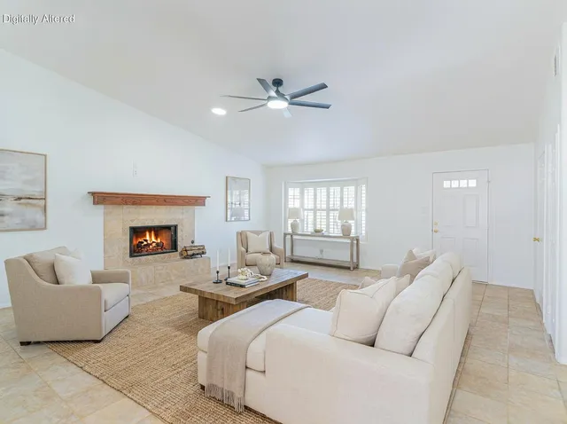 an empty room with a window and ceiling fan