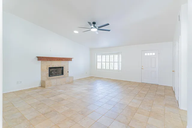 an empty room with closet and ceiling fan