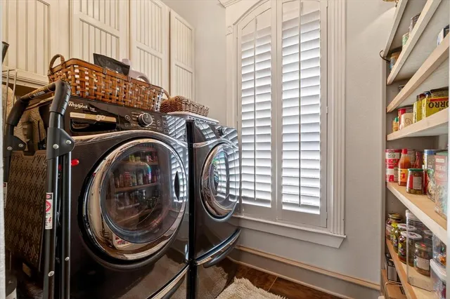 a dining hall with stainless steel appliances kitchen island granite countertop a table chairs and a refrigerator