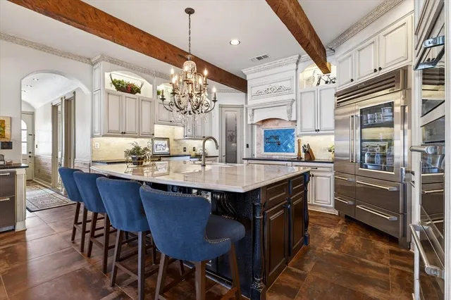 a kitchen with stainless steel appliances granite countertop a stove and cabinets