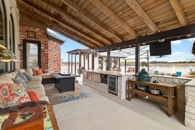a view of a patio with dining table and chairs