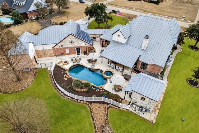 an aerial view of a house with swimming pool