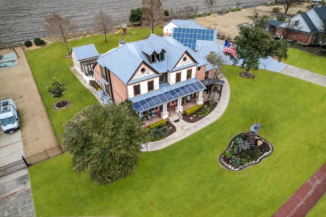 a front view of a house with garden and patio