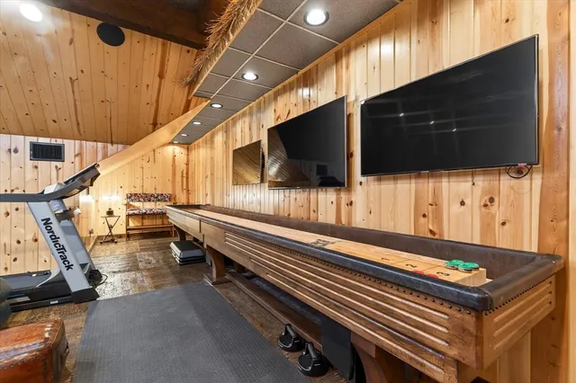 a projector room with furniture and a flat screen tv