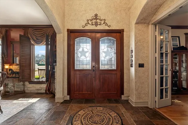 a view of entryway and hall with wooden floor