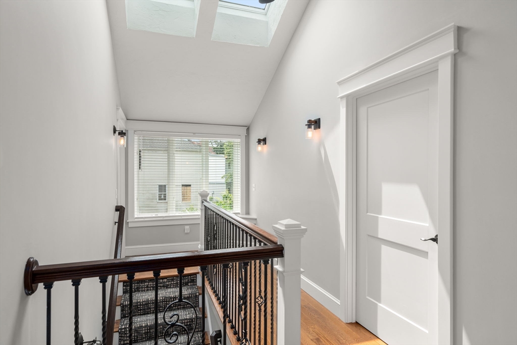 21 Prospect Street Maynard, MA 01754 - Photo 22 of 40 a view of a hallway with wooden floor and staircase