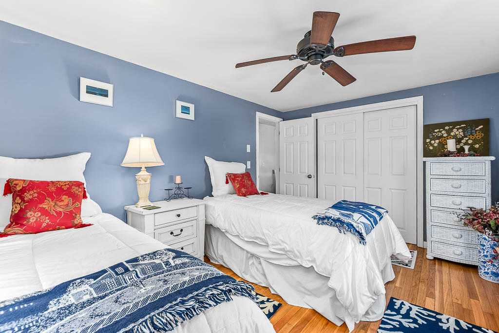 21 Spinning Brook Road South Yarmouth, MA 02664 - Photo 11 of 21 a bedroom with a bed and a chandelier