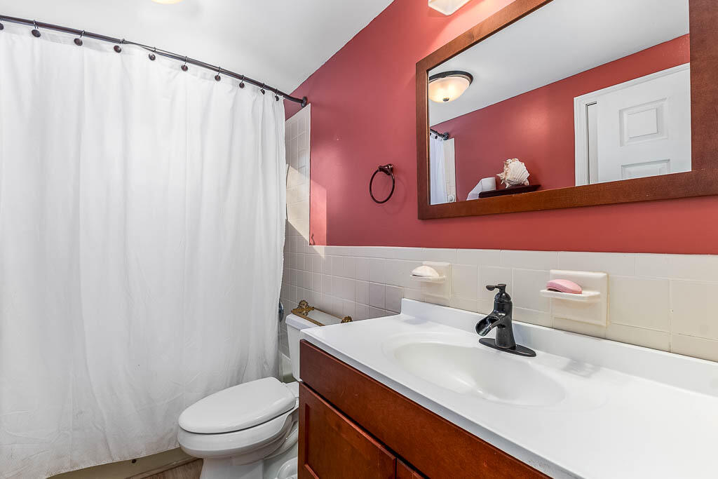 21 Spinning Brook Road South Yarmouth, MA 02664 - Photo 12 of 21 a bathroom with a toilet a sink and mirror