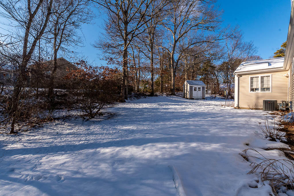21 Spinning Brook Road South Yarmouth, MA 02664 - Photo 19 of 21 a view of a house with a yard covered in snow