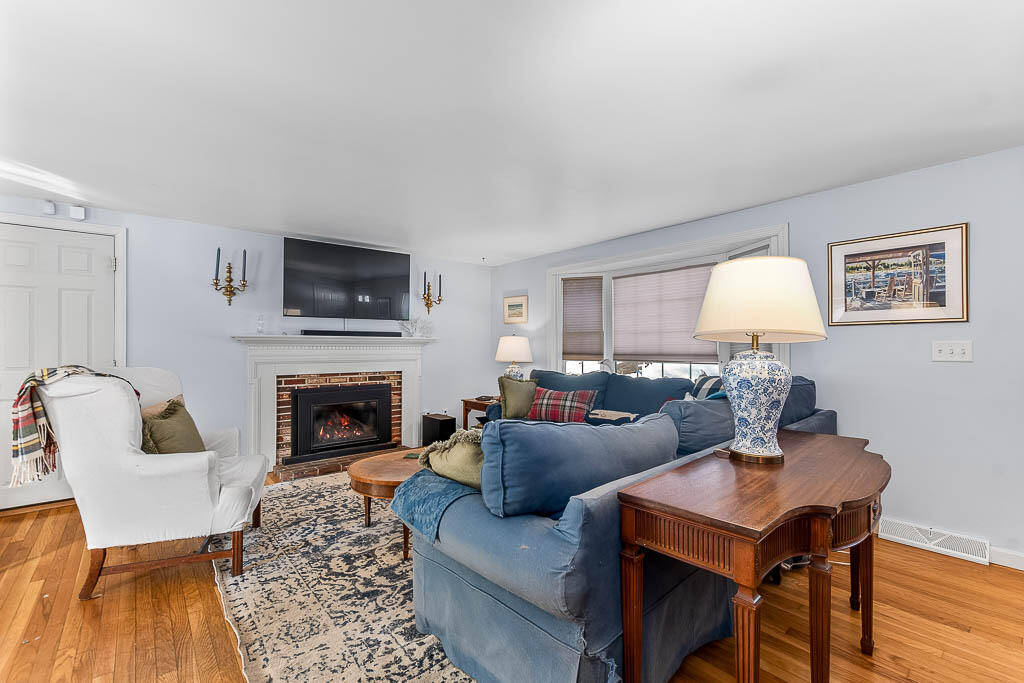 21 Spinning Brook Road South Yarmouth, MA 02664 - Photo 4 of 21 a living room with furniture a fireplace and a flat screen tv