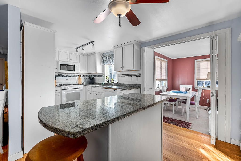 21 Spinning Brook Road South Yarmouth, MA 02664 - Photo 7 of 21 a kitchen with stainless steel appliances granite countertop a sink a stove and a dining table