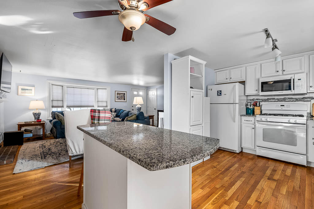 21 Spinning Brook Road South Yarmouth, MA 02664 - Photo 8 of 21 a kitchen with stainless steel appliances granite countertop a stove and a sink