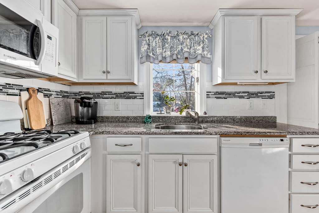 21 Spinning Brook Road South Yarmouth, MA 02664 - Photo 9 of 21 a kitchen with granite countertop a sink stove and cabinets