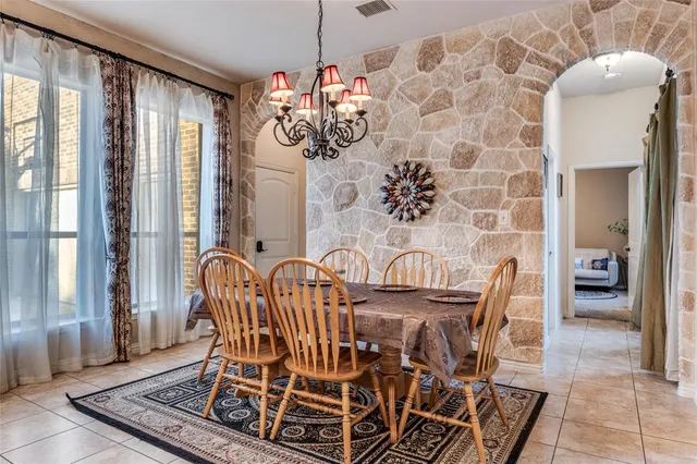 a view of a dining room with furniture and chandelier