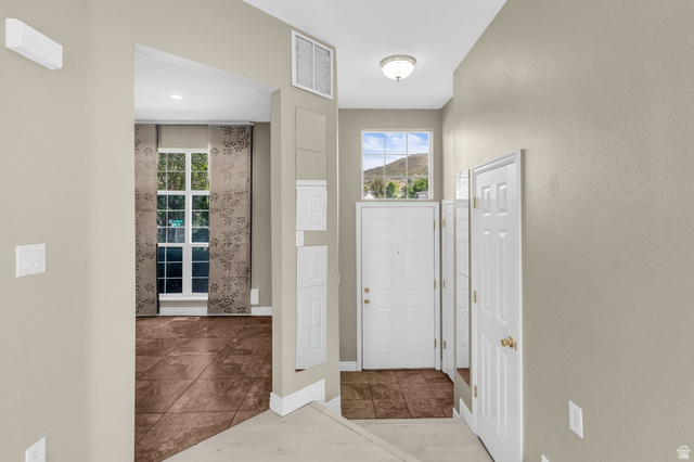 14108 Pepi Band Road Draper, UT 84020 - Photo 11 of 36 Entryway featuring neutral wall tones and a transom window with mountain scenery