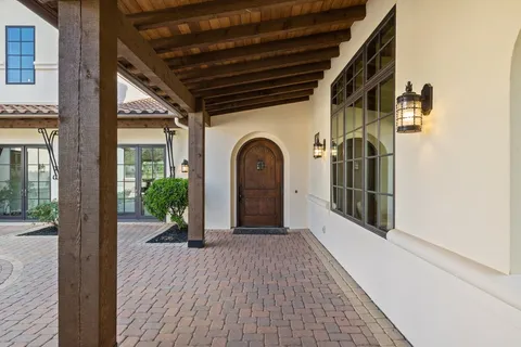a dining room with furniture and a floor to ceiling window