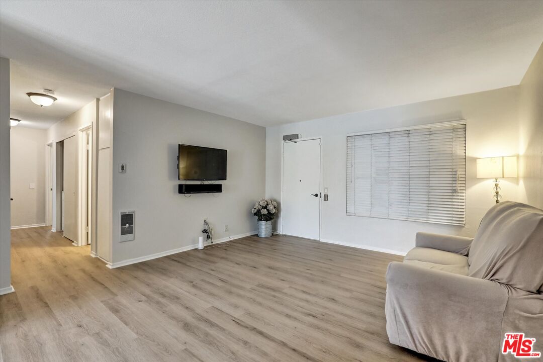 82 Eagle Point, Unit 43 Irvine, CA 92604 - Photo 12 of 35 a living room with furniture and a flat screen tv