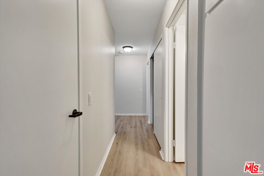 82 Eagle Point, Unit 43 Irvine, CA 92604 - Photo 13 of 35 a view of a hallway with wooden floor and a bathroom
