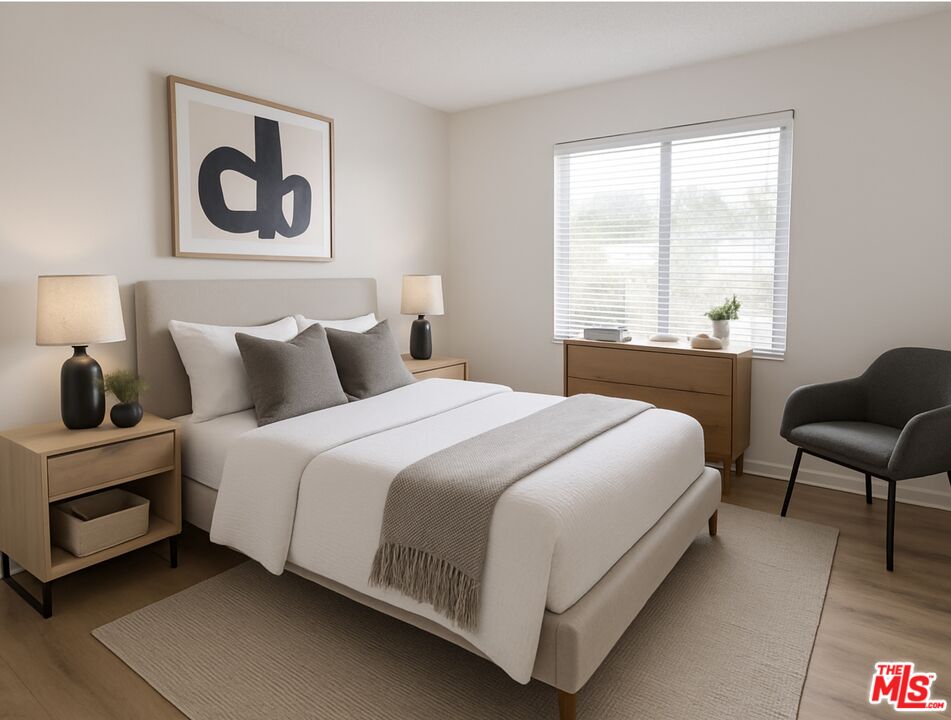 82 Eagle Point, Unit 43 Irvine, CA 92604 - Photo 20 of 35 a bedroom with a bed and a table with chair