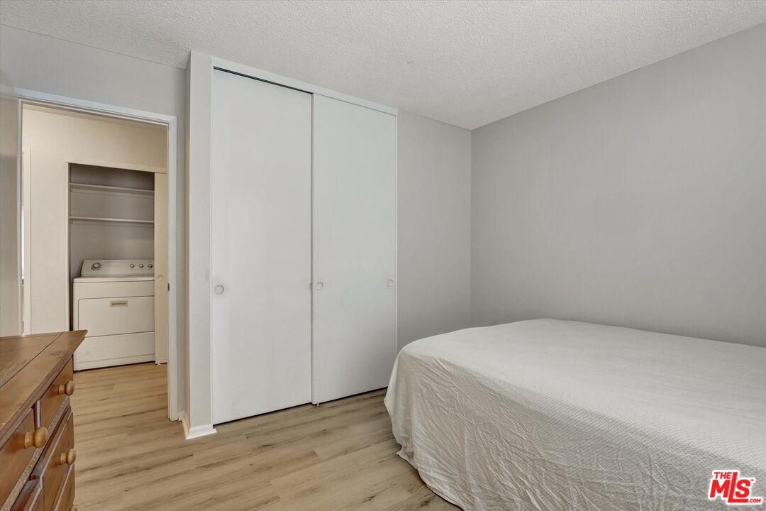 82 Eagle Point, Unit 43 Irvine, CA 92604 - Photo 26 of 35 a bedroom with a bed and wooden floor