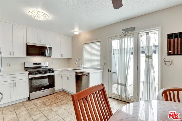 a kitchen with a sink appliances and cabinets