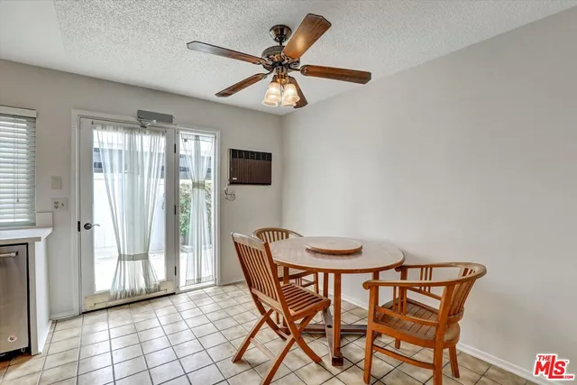 a view of a dining room with furniture and a chandelier