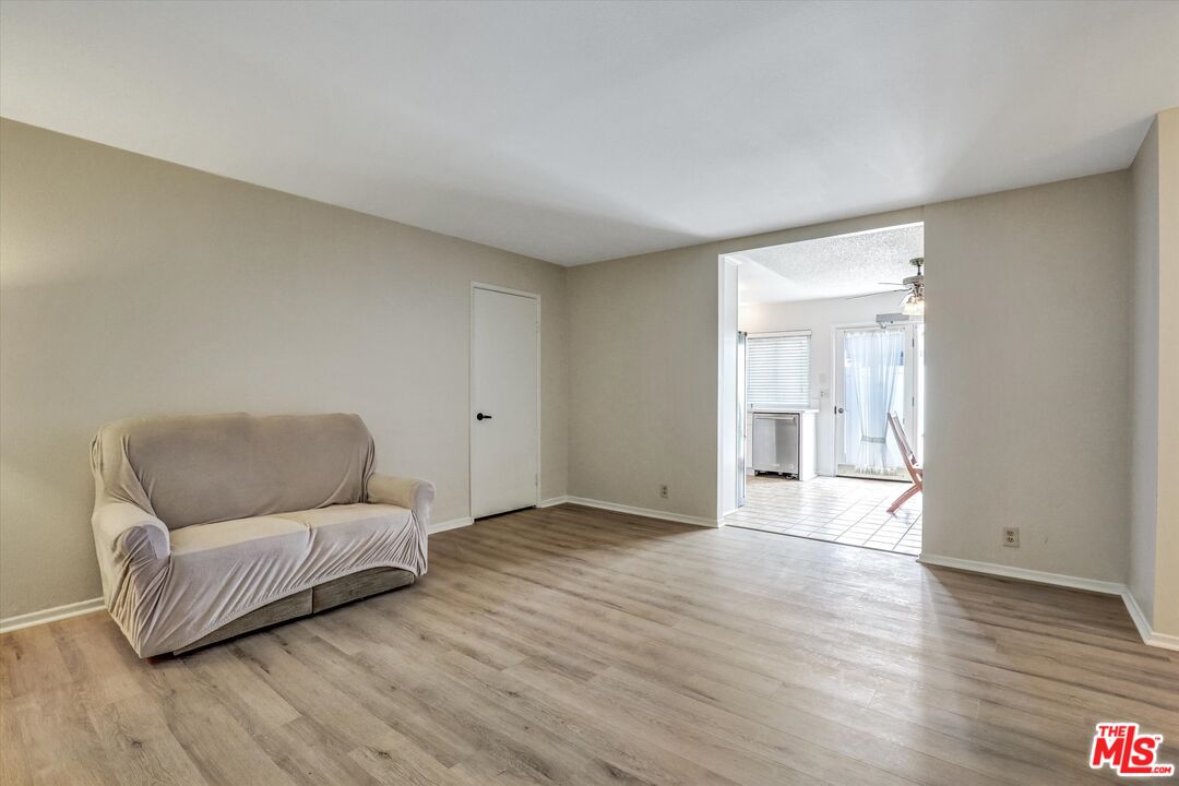 82 Eagle Point, Unit 43 Irvine, CA 92604 - Photo 9 of 35 a living room with furniture and a wooden floor