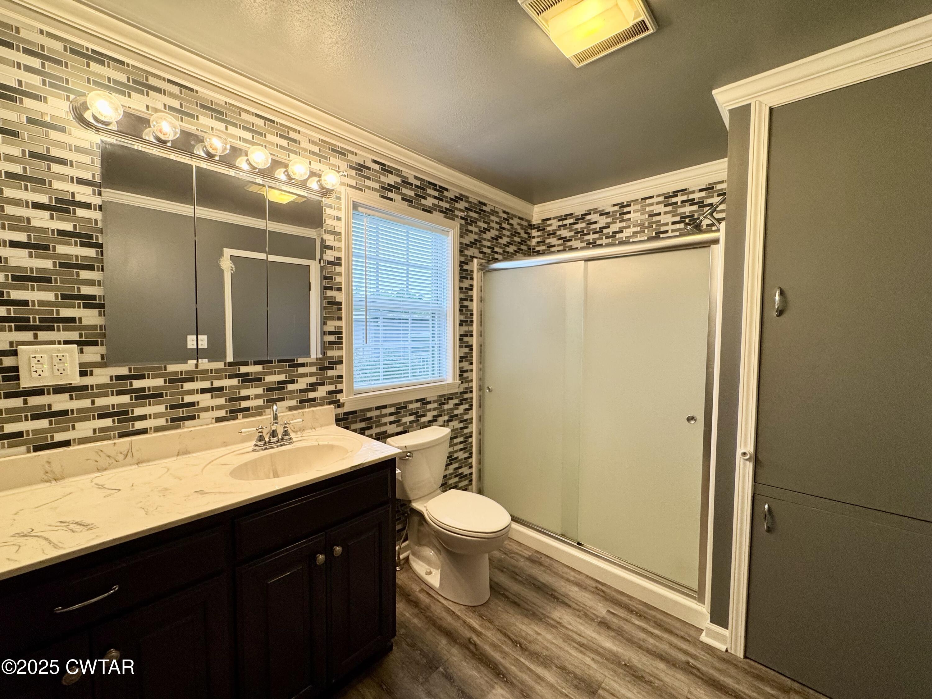 4985 McClard Road Union City, TN 38261 - Photo 13 of 27 a bathroom with a granite countertop sink toilet and shower