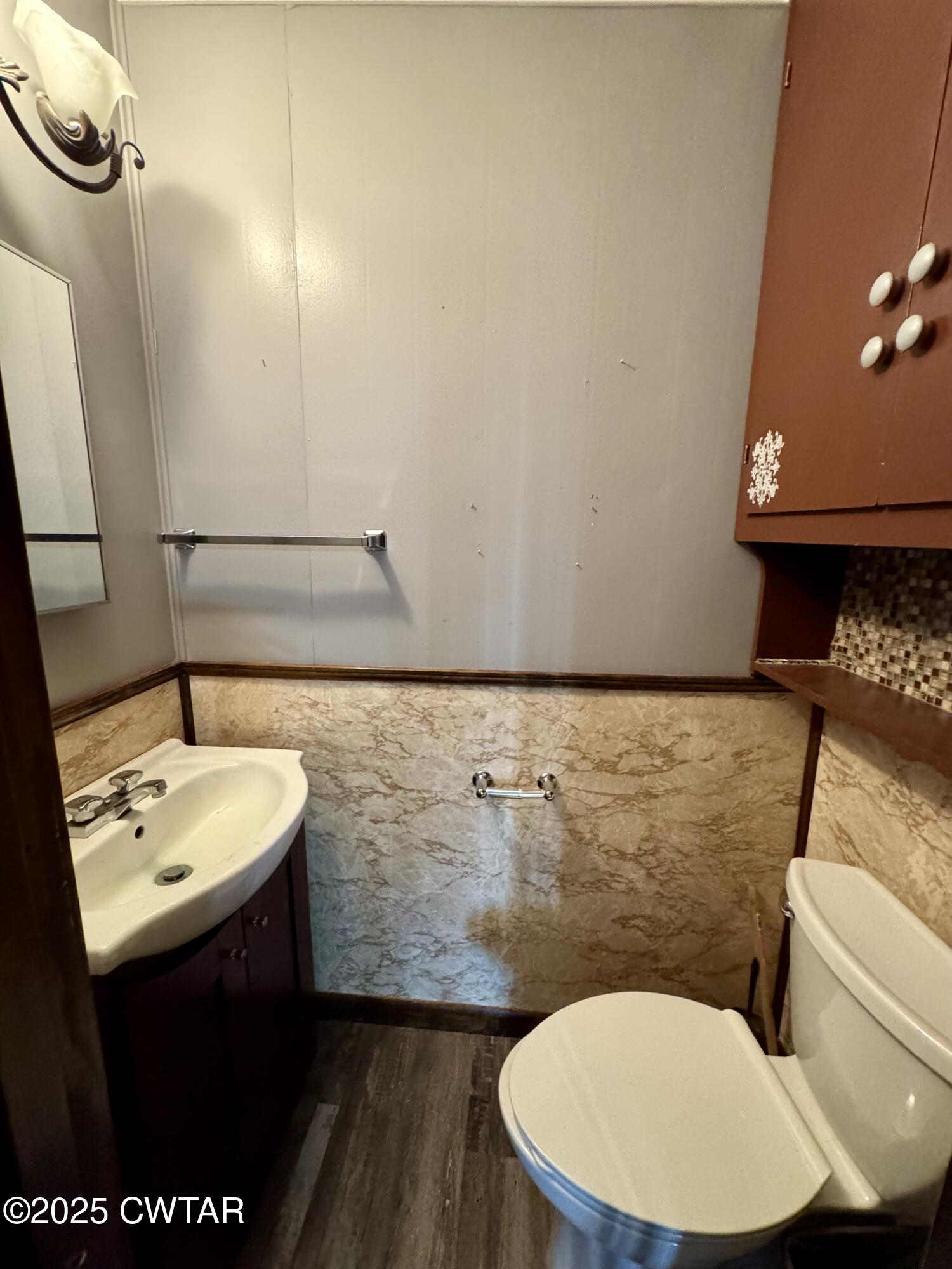 4985 McClard Road Union City, TN 38261 - Photo 16 of 27 a bathroom with a sink mirror vanity and toilet