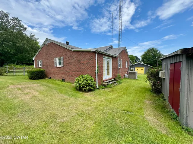 a view of backyard with trampoline