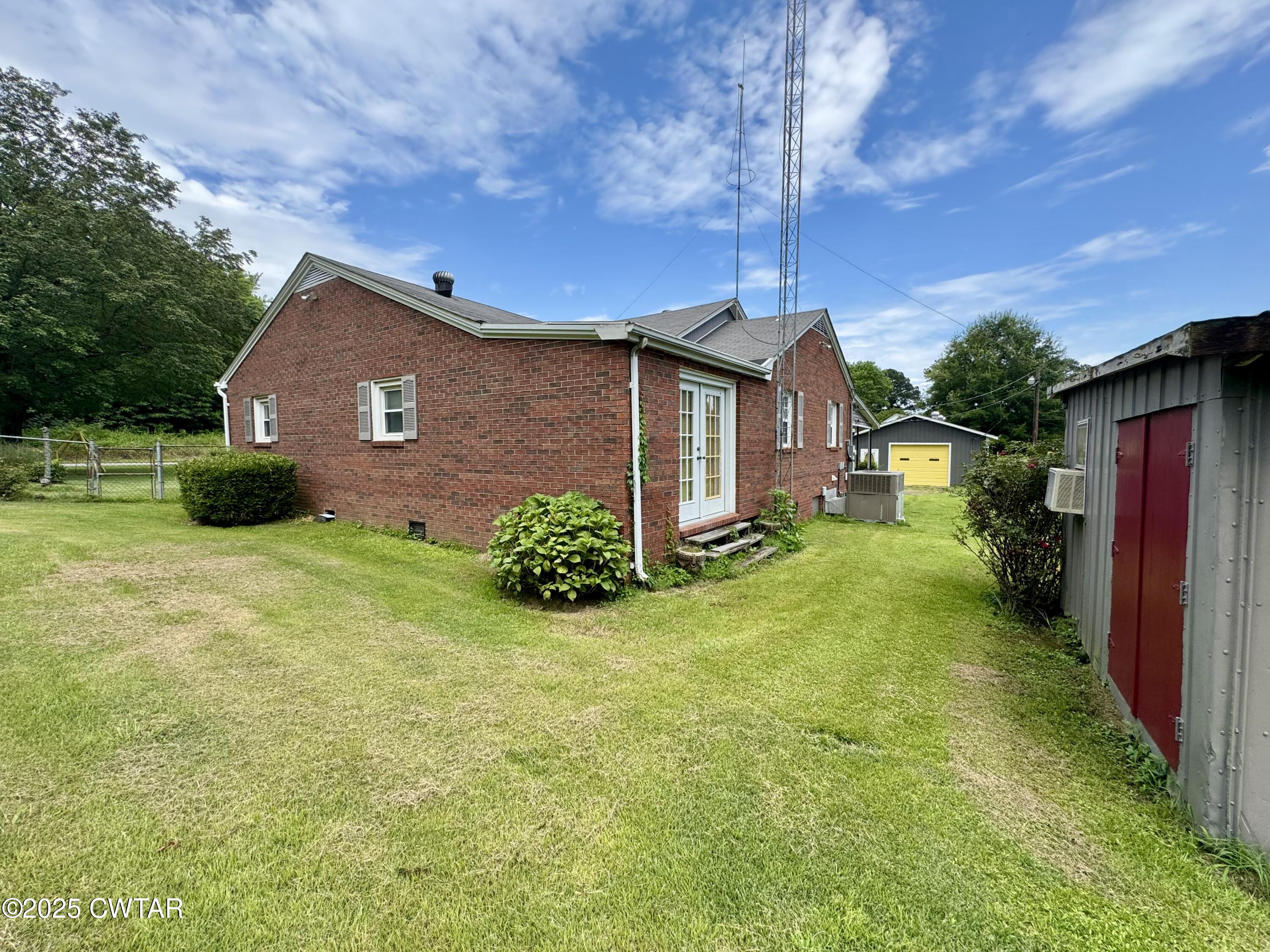 4985 McClard Road Union City, TN 38261 - Photo 21 of 27 a brick house with a big yard plants and big trees