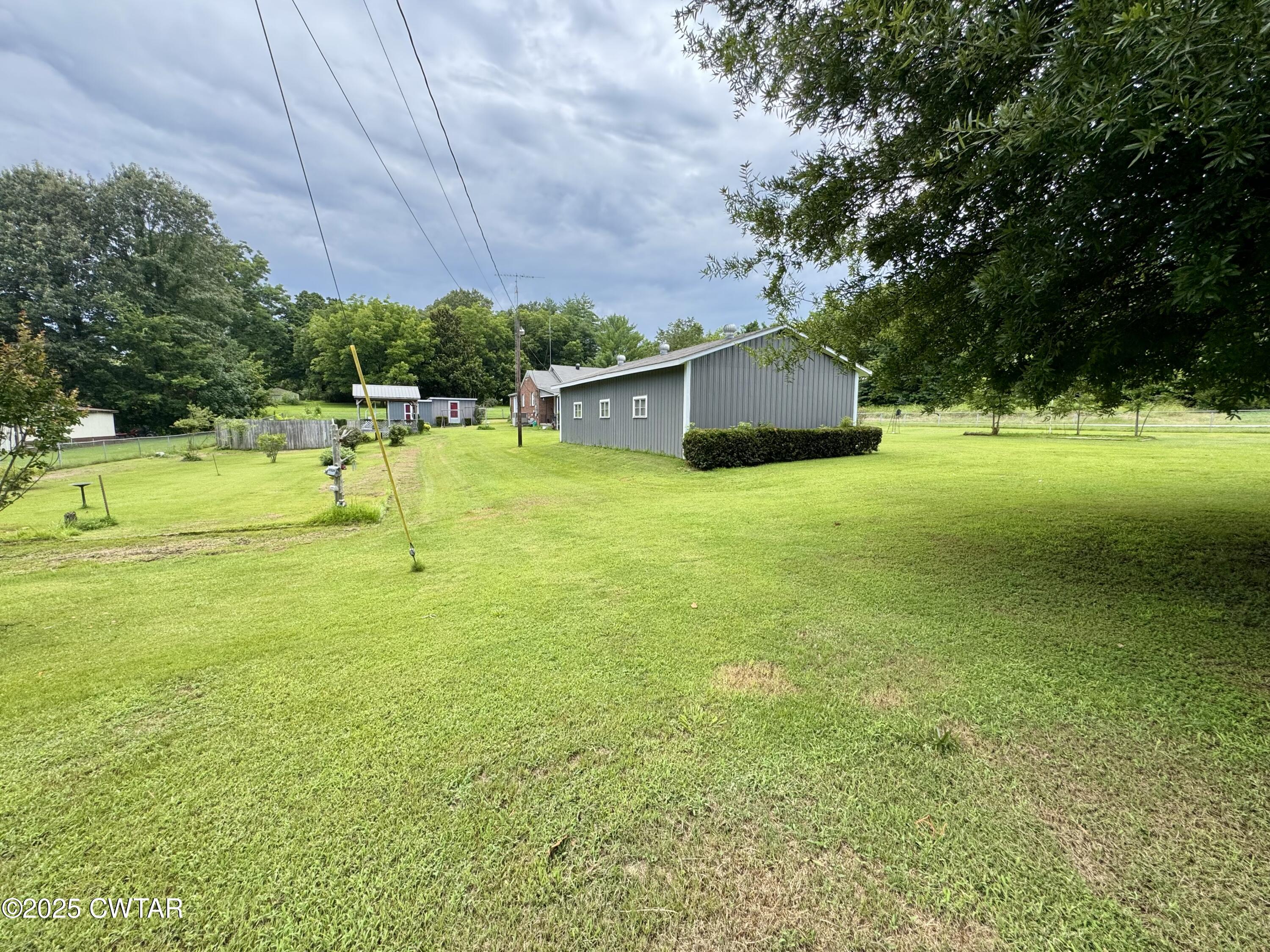 4985 McClard Road Union City, TN 38261 - Photo 24 of 27 a view of a big yard with a house and large trees