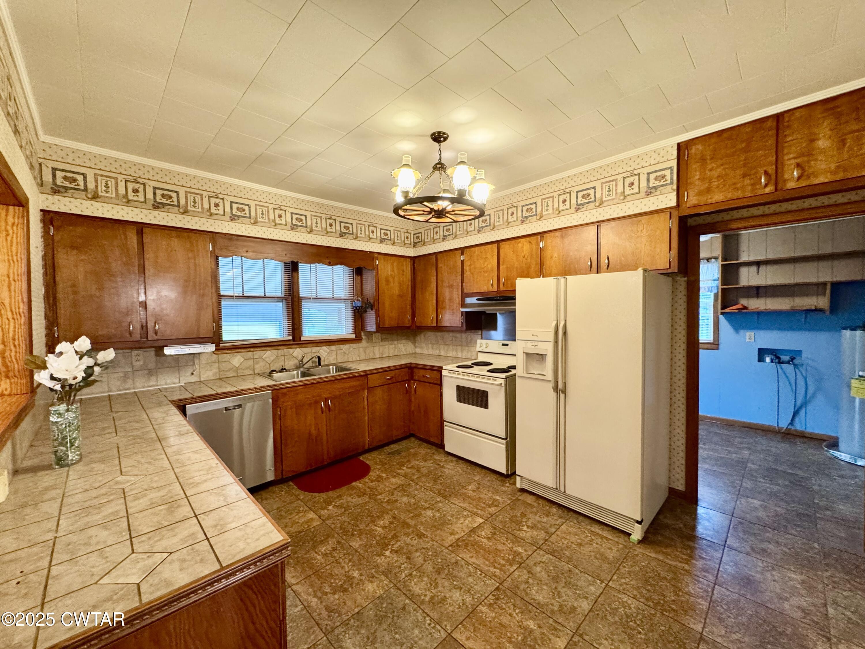 4985 McClard Road Union City, TN 38261 - Photo 5 of 27 a kitchen with granite countertop a sink stove and refrigerator