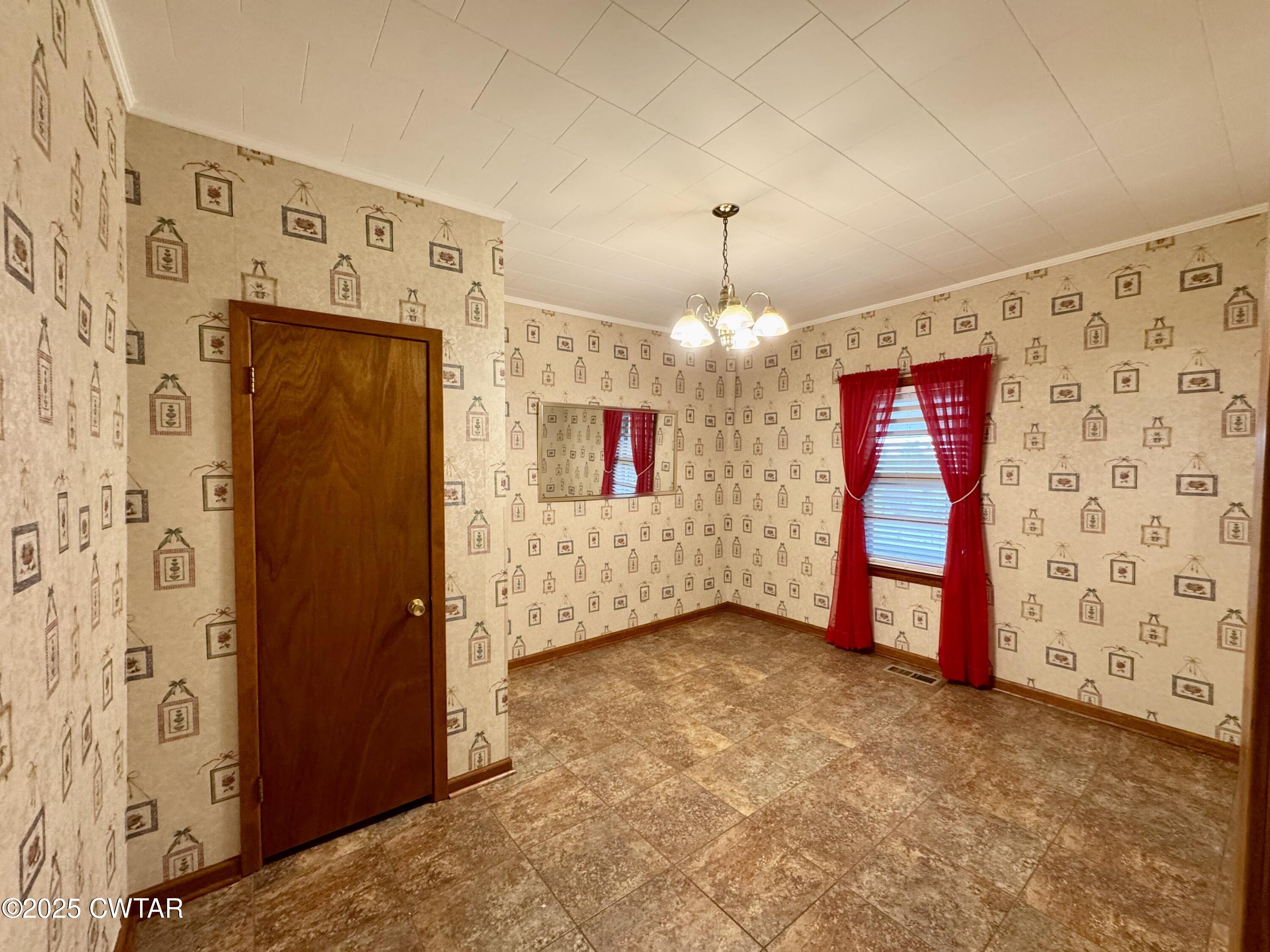 4985 McClard Road Union City, TN 38261 - Photo 6 of 27 a view of a hallway with a chandelier
