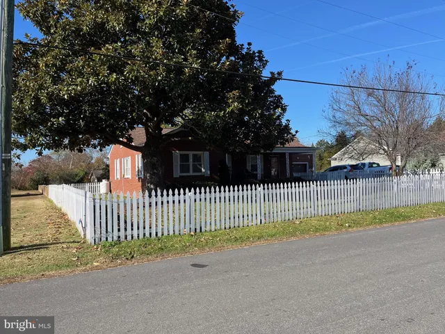 a view of a wooden fence next to a road