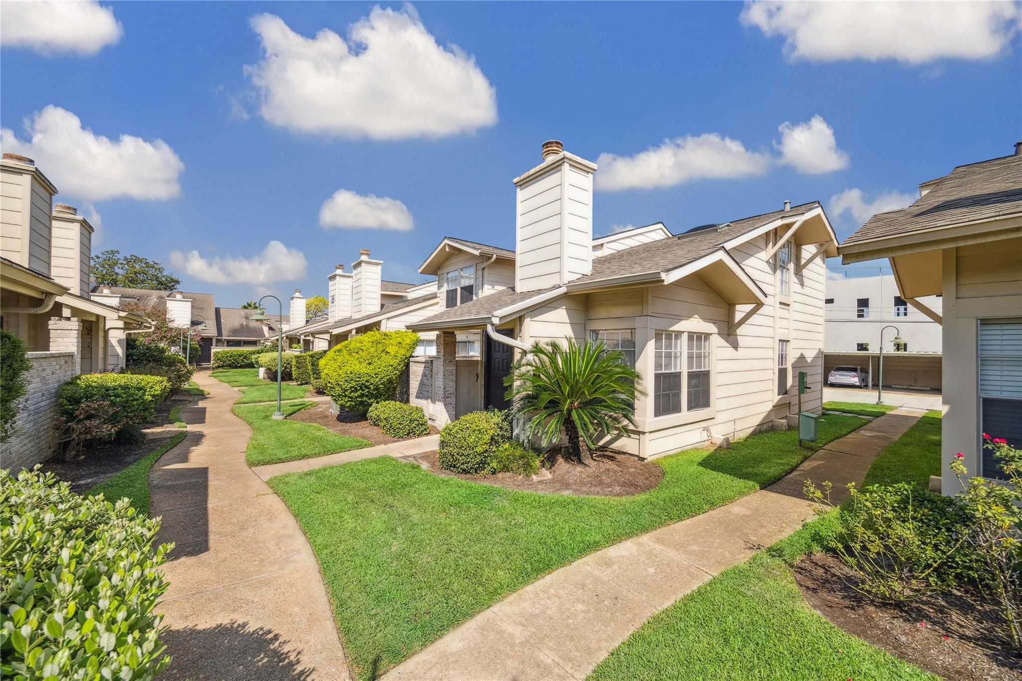 a front view of a house with a garden and outdoor seating