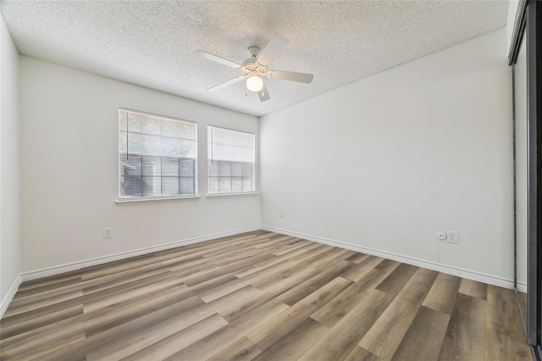 13020 Leader Street, Unit 927 Houston, TX 77072 - Photo 12 of 21 wooden floor in an empty room with a window