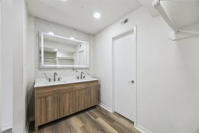 a bathroom with a double vanity sink mirror and