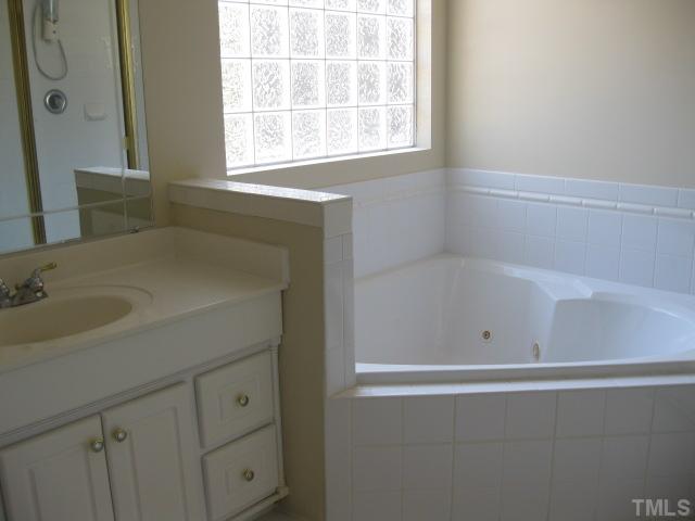 3709 Barwell Road Raleigh, NC 27610 - Photo 15 of 25 a bathroom with a sink and a bathtub