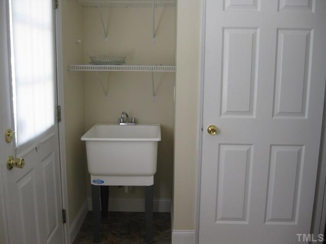 3709 Barwell Road Raleigh, NC 27610 - Photo 18 of 25 a bathroom with a sink a toilet and a window