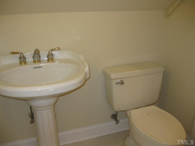 3709 Barwell Road Raleigh, NC 27610 - Photo 20 of 25 a bathroom with a sink a toilet and bathtub