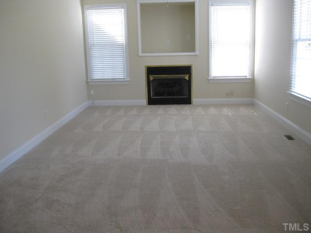3709 Barwell Road Raleigh, NC 27610 - Photo 7 of 25 an empty room with windows and fireplace