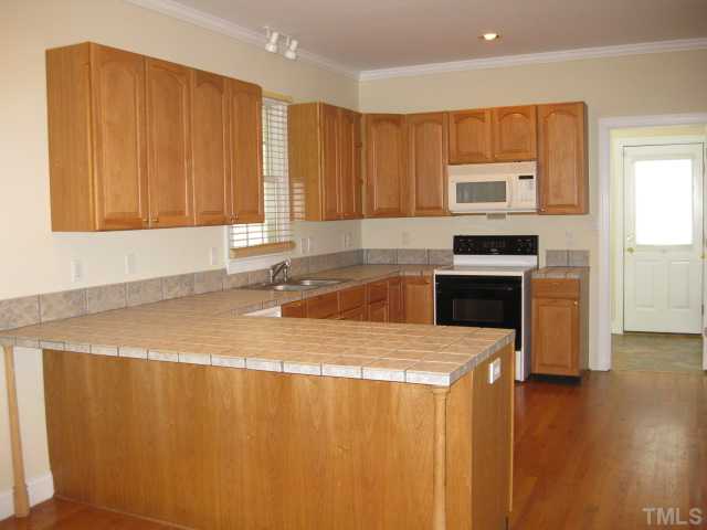 3709 Barwell Road Raleigh, NC 27610 - Photo 8 of 25 a kitchen with stainless steel appliances granite countertop a sink a stove a microwave a counter space and cabinets