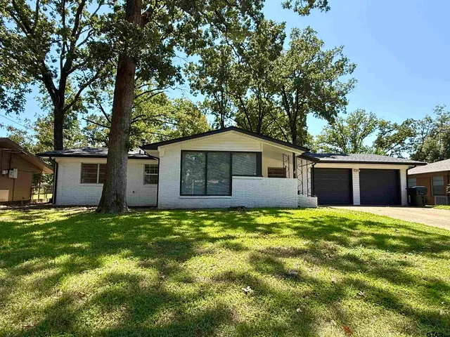 a house view with a sitting space and garden