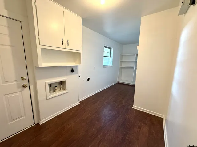 a view of a hallway with wooden floor and floors