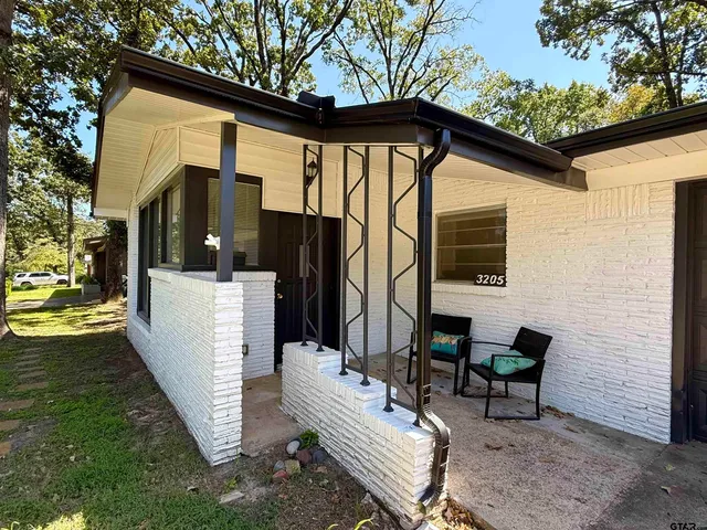 a view of a patio with a yard