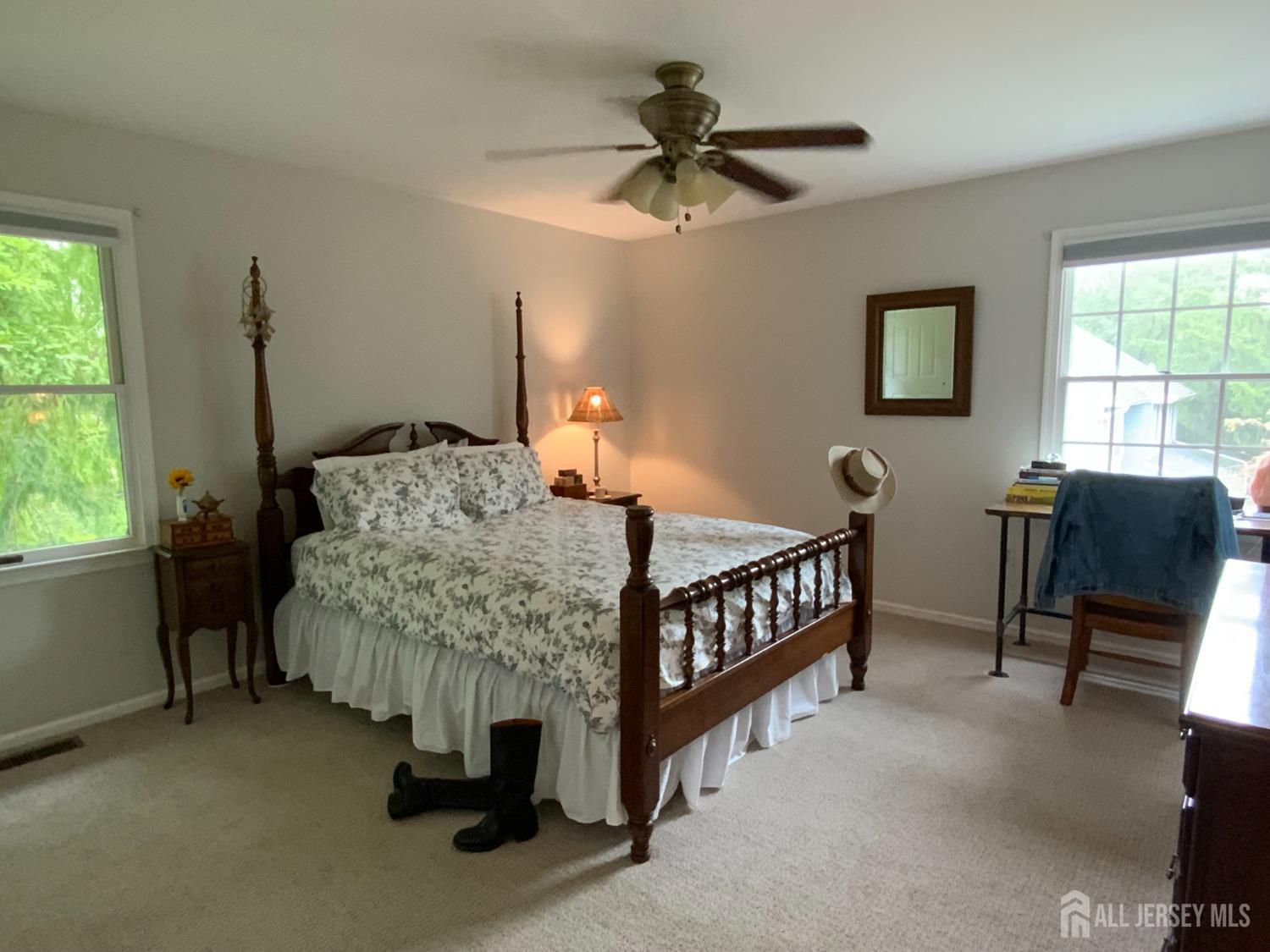 52 Wexford Drive Monmouth Junction, NJ 08852 - Photo 36 of 52 a bedroom with a bed a chandelier and dresser