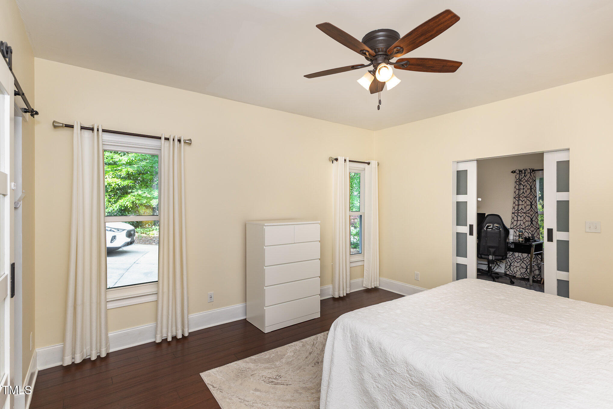 7901 Farnham Court Raleigh, NC 27615 - Photo 9 of 30 a bedroom with a bed and a chandelier