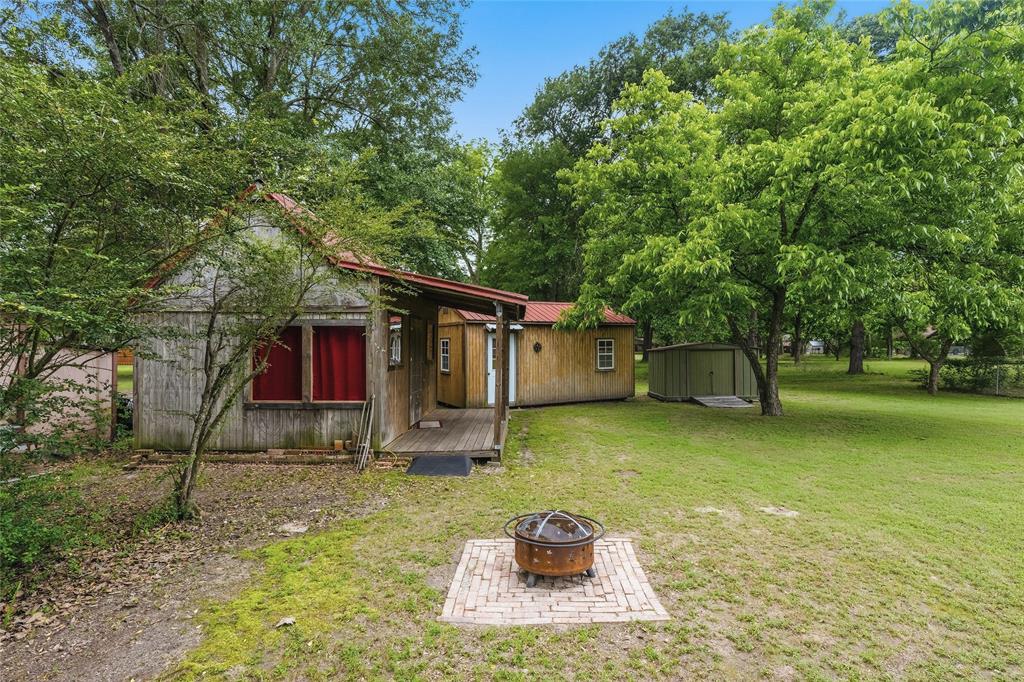 2917 Harlow Road Commerce, TX 75428 - Photo 34 of 40 a backyard of a house with barbeque oven table and chairs